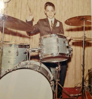 Arthur as a youth playing the drums.